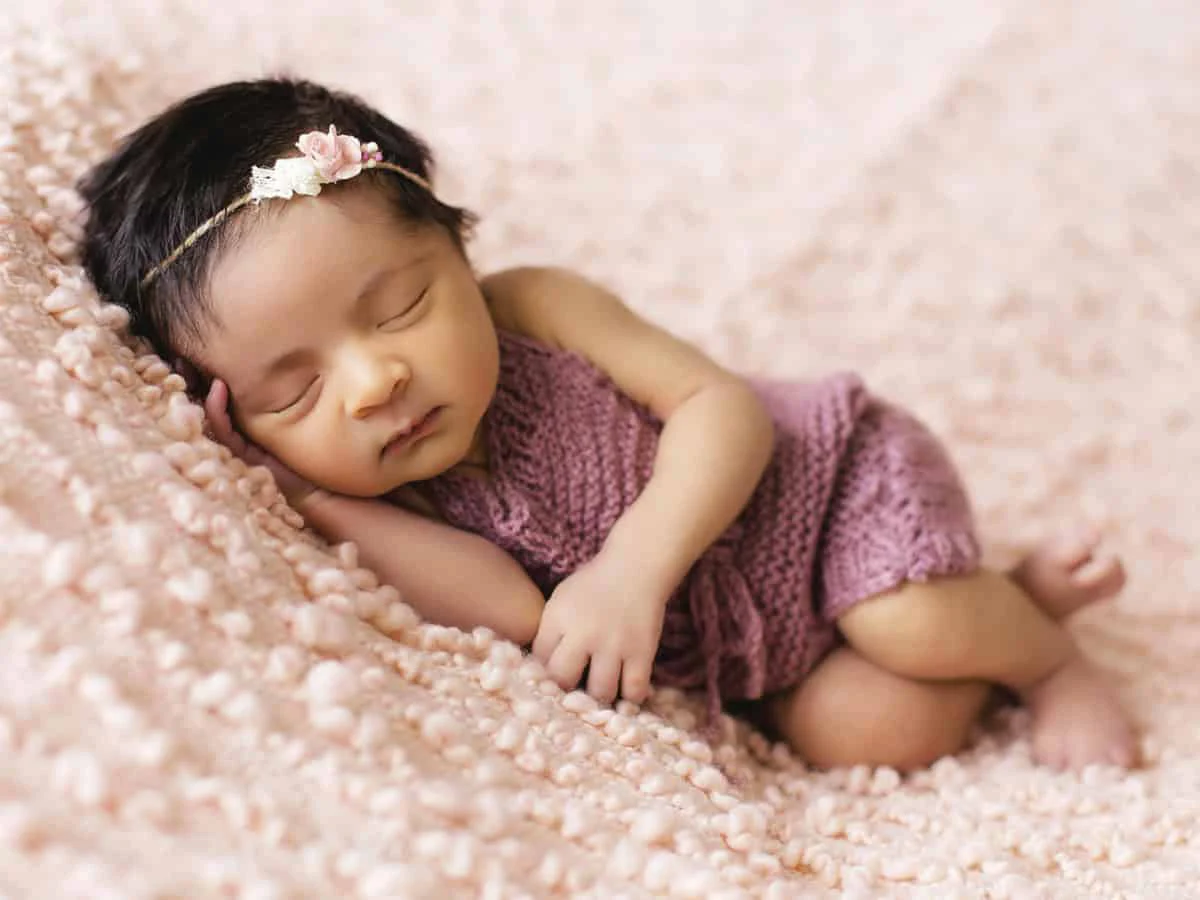 Sleeping newborn pink blanket retouching after